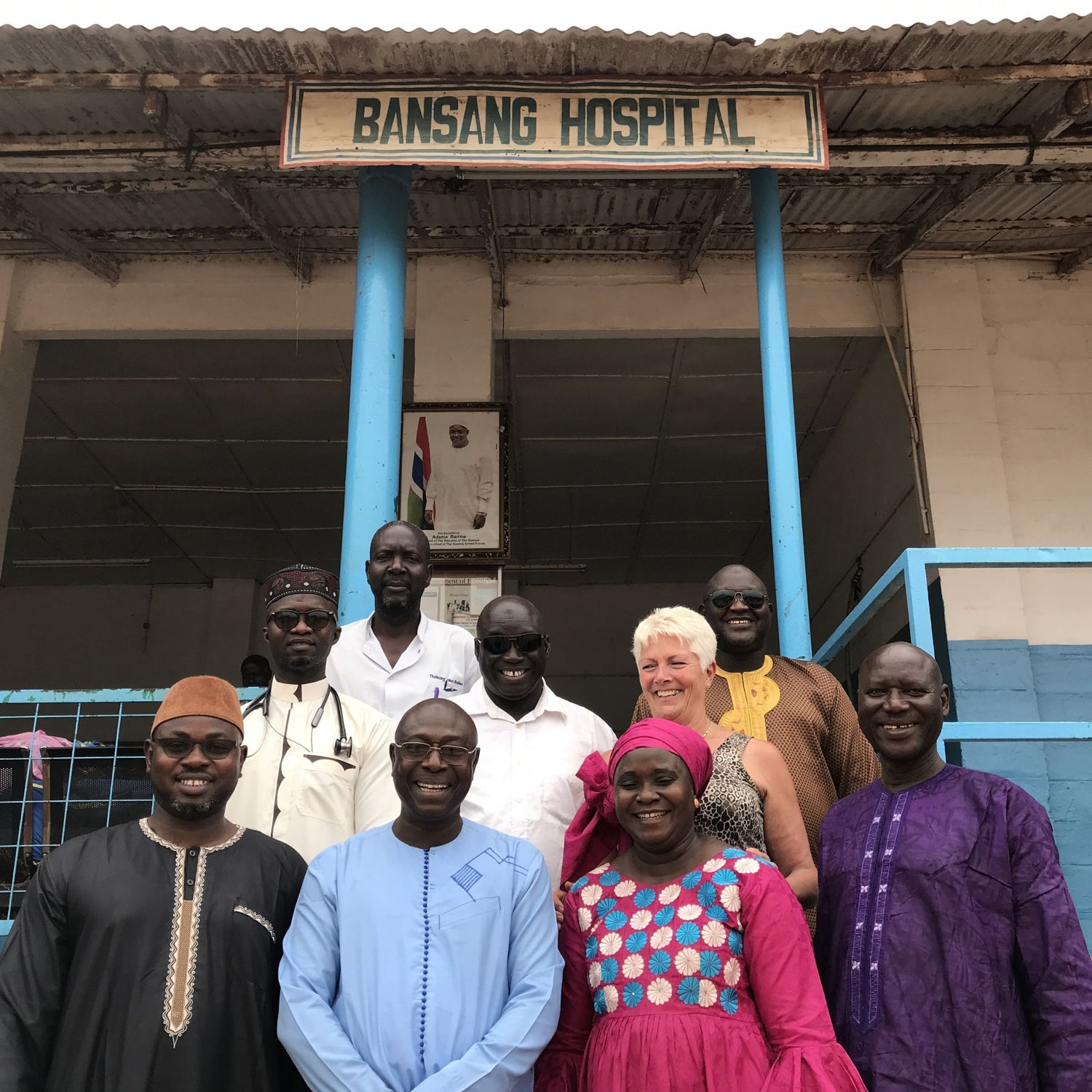 Anita and community standing in front of Bansang Hospital